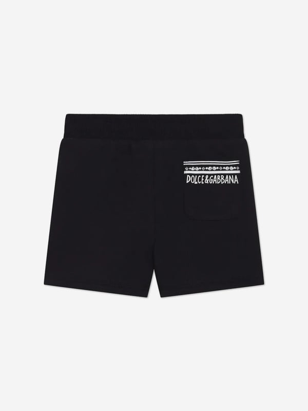 Introduce a touch of Italian elegance to your little one's wardrobe with the Baby Boys Logo Shorts in Navy by Dolce Gabbana. Perfect for SS2025, these shorts blend impeccable style with ultimate comfort. Here's why they're a wardrobe essential Crafted in Italy Meticulously made, ensuring premium quality and durability. Chic Design Emblazoned with the iconic Dolce Gabbana logo for an unmistakable designer touch. Comfortable Fit Soft fabric ensures comfort for all-day play and adventures. Ideal for any Occasion Versatile and stylish, perfect for casual outings or special events.Enhance your child's closet with these luxurious shortsstyle and comfort in one delightful package!