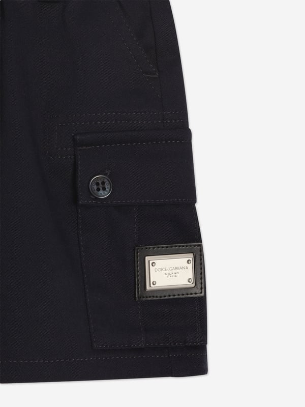 Introducing the exquisite Baby Boys Cargo Shorts in Navy by Dolce Gabbana, a splendid addition to your little cherub's wardrobe for SS2025! Marvel in the Italian craftsmanship stylish flair of this piece Italian Elegance Meticulously tailored in Italy, these shorts promise unmatched quality sophisticated style. Classic Navy Hue The deep blue shade offers versatility and a touch of elegance to any outfit. Comfort Meets Style Designed with your child's comfort in mind, ensuring they look charming without compromising on ease.Perfect for any occasion, these cargo shorts will make your boy the epitome of youthful fashion! Order now to embrace timeless elegance.