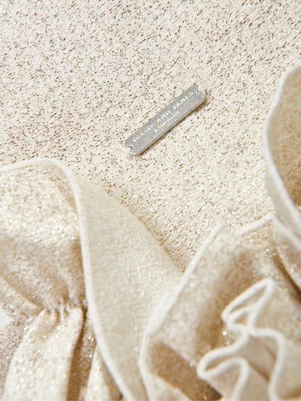Jessie and James embody timeless elegance and modern charm. This girls dream on frilly flower dress is reflective of the label's distinctive care and craftsmanship. It has exaggerated ruffles at the bottom hem with a classic shirt collar. Radiates an opulent, shimmering finish. Excusive to Childsplay Short Sleeves 59 Polyester, 28 Polyamide, 13 Metallic Fibre