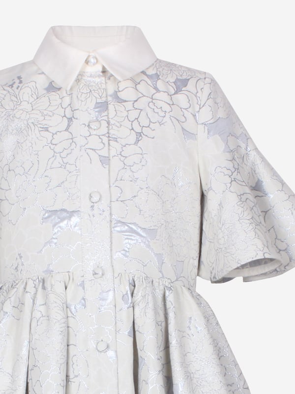 Jessie and James embody timeless elegance and modern charm. Crafted with a sophisticated jacquard floral print, this girls little sister blue clouds jacquard dress combines classic style with contemporary flair. Woven in ice blue. It showcases a front button fastening, classic collar, flared cuffs, and an elegant peplum hem. Outer Polyester 50, Cotton 39, Metallic Fibre 11 Lining Cotton 100