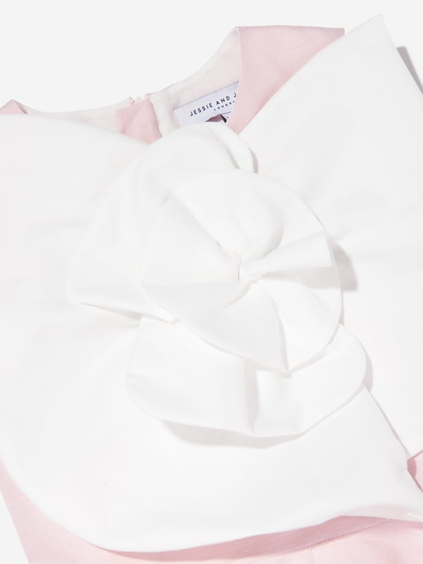 Introducing the exquisite Girls Peony Flower Dress in Pink by Jessie and James, a quintessential addition for SS2025, designed to enchant and delight. Elegant Design Crafted with a delicate peony print, exuding timeless grace and femininity. Luxurious Fabric Tailored from premium fabric, ensuring both comfort and durability for any occasion. Vibrant Pink Hue A charming, rich pink shade that captures the essence of spring and fashion-forward allure.Enrich your little girl's wardrobe with this splendid piece from Jessie and James. Secure the season's must-have now!