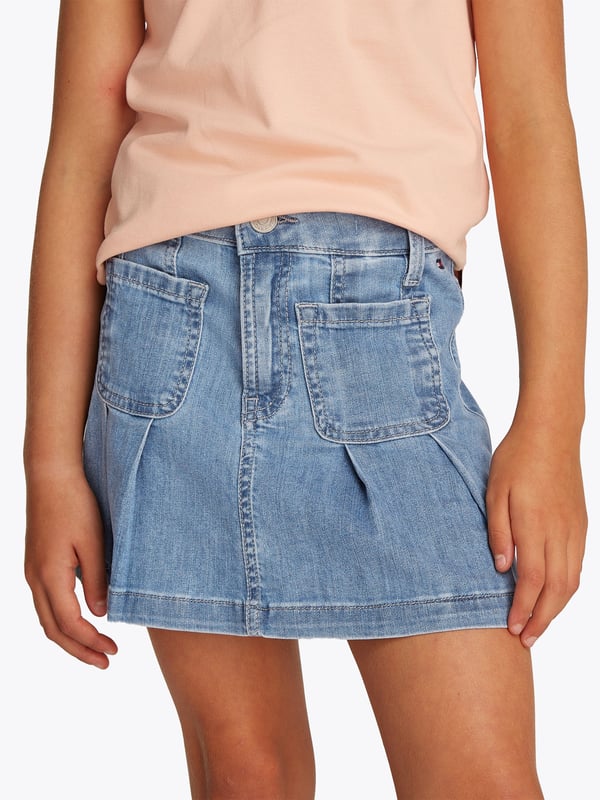 Tommy Hilfiger Girls Pleated Denim Skirt in Blue Introducing the Tommy Hilfiger Girls Pleated Denim Skirt in Blue an essential addition for SS2025. Crafted with flair, this skirt encapsulates both comfort and fashion for your young one. Key features include Classic Pleated Design Chic pleats merge timeless style with a fresh, youthful twist. Vibrant Blue Hue A striking blue shade complements any top, ensuring versatility across seasons. Quality Denim Fabrication Durably constructed to withstand the joys of childhood. Signature Branding Embellished with the iconic Tommy Hilfiger logo for an exquisite touch.Revitalize your girl's wardrobe with this delightful, versatile piece.