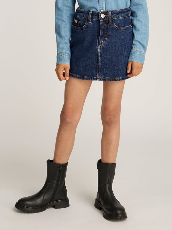 Delight in the elegance of Calvin Klein's Girls Rinse Denim Mini Skirt in Blue, a quintessential piece for SS2025. Crafted with unmatched finesse, this skirt promises to elevate your girl's wardrobe with its chic design and superior comfort. Exquisite Craftsmanship Tailored by Calvin Klein, synonymous with high-end fashion. Vibrant Blue Hue Adds a pop of colour, perfect for spring and summer outings. Versatile Styling Pairs effortlessly with both casual tops and smart blouses. Durable Fabric Ensures longevity and ease of maintenance.Grace her collection with this stylish staple order now to embrace timeless sophistication!