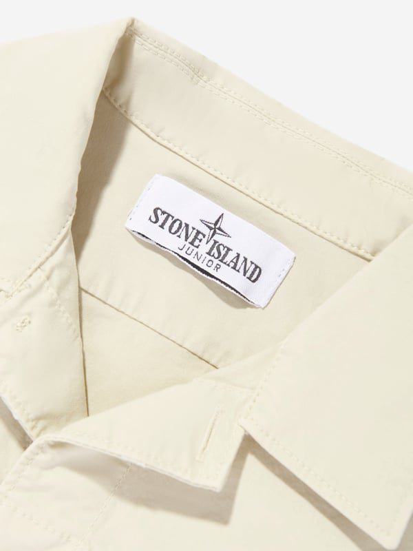 Introducing the epitome of Italian craftsmanship, the Boys Logo Pocket Shirt in Beige by Stone Island Junior. Perfect for the discerning young gentleman's SS2025 wardrobe, this shirt seamlessly blends sophistication with playful charm. Exquisite Italian Craftsmanship Meticulously made in Italy, promising unparalleled quality and durability. Subtle Logo Detailing Features Stone Island's signature compass logo, tastefully positioned to elevate look. Tailored for Comfort Constructed from premium fabrics for all-day comfort and ease. Versatile Beige Hue A stylish, easy-to-pair colour ensuring endless outfit possibilities.Revamp your boy's style with this chic and timeless piece. Order now for a touch of luxury!