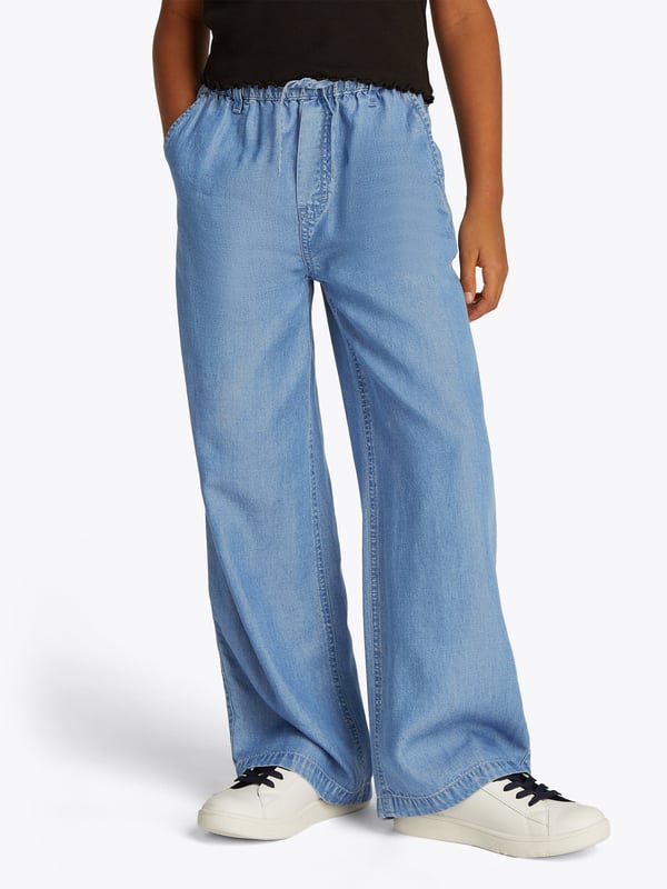 Unveil timeless elegance with the Tommy Hilfiger Girls Chambray Wide Leg Pants in striking blue, quintessential for SS2025. Impeccably tailored, these pants promise both flair comfort for a sophisticated young wardrobe. Key features include Classically Chic Exude an air of understated sophistication with a breezy, wide-leg design. Premium Fabric Crafted from the finest chambray for comfort durability. Versatile Style Easily pairs with both casual tees and polished tops.Elevate her ensemble with these exquisite pants from Tommy Hilfiger.