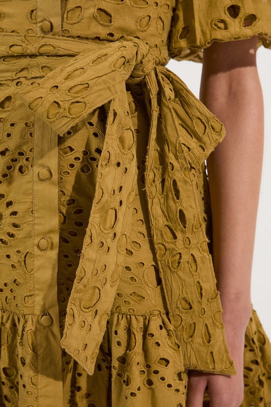 This Karen Millen cotton broderie mini dress combines timeless charm with contemporary styling. The breathable fabric ensures comfort for all-day wear, whilst the intricate eyelet detailing adds texture and visual interest. Style with leather sandals and a woven basket bag for a casual summer look or with espadrille wedges and delicate gold jewellery for elevated occasions. The adjustable tie waist allows for a customised fit, making this piece a flattering addition to your warm-weather wardrobe.  Intricate broderie anglaise pattern Collared neckline with button-down front detail Flutter sleeves Adjustable tie waist Playful ruffle hem detail