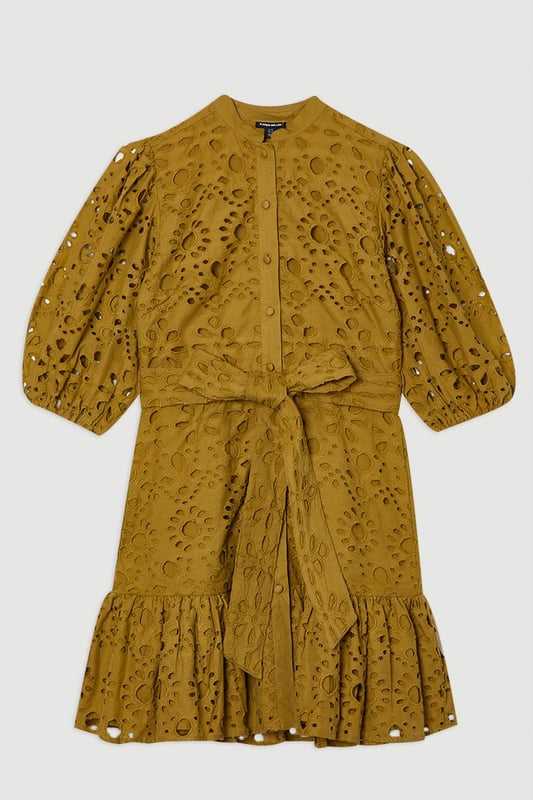 This Karen Millen cotton broderie mini dress combines timeless charm with contemporary styling. The breathable fabric ensures comfort for all-day wear, whilst the intricate eyelet detailing adds texture and visual interest. Style with leather sandals and a woven basket bag for a casual summer look or with espadrille wedges and delicate gold jewellery for elevated occasions. The adjustable tie waist allows for a customised fit, making this piece a flattering addition to your warm-weather wardrobe.  Intricate broderie anglaise pattern Collared neckline with button-down front detail Flutter sleeves Adjustable tie waist Playful ruffle hem detail