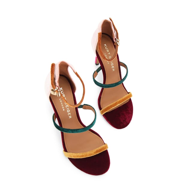 This Kurt Geiger Park Lane heel is crafted from a tonal pink velvet. The heel is enclosed with gold buckle on the ankle strap as well as small gold branded stud detail at the heel. Heel height: 9.5cm.