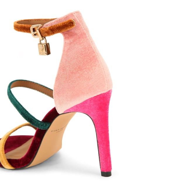 This Kurt Geiger Park Lane heel is crafted from a tonal pink velvet. The heel is enclosed with gold buckle on the ankle strap as well as small gold branded stud detail at the heel. Heel height: 9.5cm.