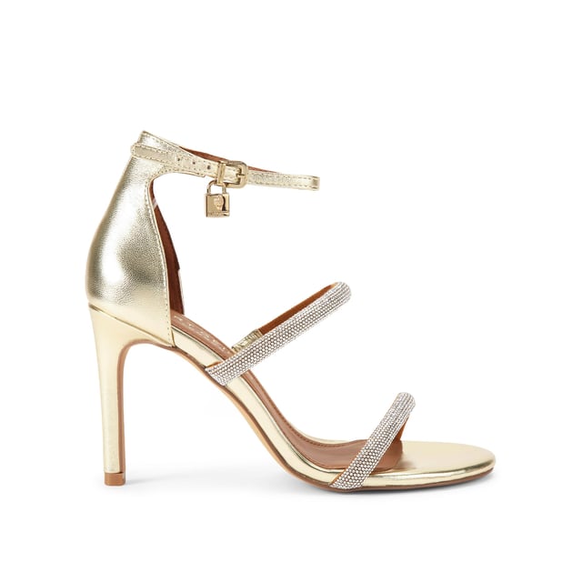 This Kurt Geiger Park Lane heel is crafted from a gold leather. The heel is enclosed with gold buckle on the ankle strap as well as small gold branded stud detail at the heel. Heel height: 9.5cm.