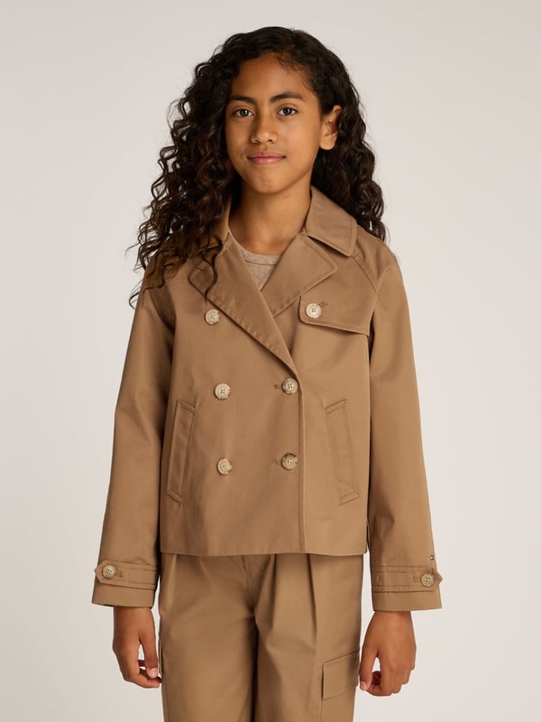 Girls Short Cotton Jacket in Brown Introducing the SS2025 must-have Tommy Hilfiger's Girls Short Cotton Jacket in a chic brown hue. Perfectly tailored for the style-conscious young lady, this piece effortlessly marries sophistication with youthful charm. Key features include Elegantly Tailored A precise, chic cut that offers both comfort and style. Premium Cotton Crafted from high-grade cotton, ensuring durability and breathability. Versatile Hue The charming brown colour complements various outfits, ideal for any occasion. Designer Appeal Branded with the prestigious Tommy Hilfiger emblem, adding a luxe touch. Elevate her wardrobe with this exquisite jacket!