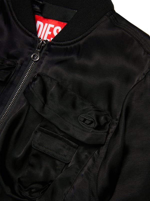 Discover the exquisite Girls Shiny Bomber Jacket in Black by Diesel a quintessential addition to any young lady's wardrobe for SS2025. Crafted with meticulous attention to detail, this piece blends timeless elegance with a contemporary edge. Here are its standout features Luxurious Gloss Finish Elevates the classic bomber with a high-shine allure, perfect for stylish festivities. Lightweight Durability Fashioned from premium materials to endure the thrills of childhood while maintaining chic. Signature Diesel Panache Emblems of the esteemed brand add an exclusive touch of class.Refresh your girl's ensemble with this distinctive jacket. Secure yours today and watch her shine with confidence!