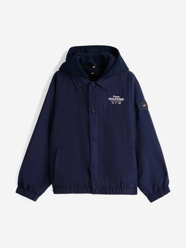 Unveil the essence of style with the Tommy Hilfiger Boys Coach 3 in 1 Jacket in sleek black, an essential for SS2025. Each detail is finely crafted for the fashionable boy Versatile Design Transforms for varying weather, ensuring stylish practicality. Superior Fabric Crafted with premium materials for unmatched comfort durability. Iconic Branding Subtle yet striking logos for that quintessential Tommy Hilfiger charm.Refine his look with this exquisite piece. Secure this timeless jacket today and let your young gentleman step out in unparalleled sophistication!