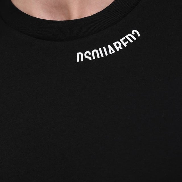Dsquared2 Cool Fit Logo Around Collar Black T-shirt Elevate your casual wardrobe with the Dsquared2 Cool Fit Logo Around Collar Black T-Shirt. Crafted from 100% premium cotton, this men's t-shirt offers exceptional comfort and breathability for all-day wear. Its sleek black design is enhanced by the distinctive Dsquared2 logo elegantly encircling the collar, adding a subtle yet stylish statement. Perfect for pairing with jeans or layering under jackets, this t-shirt combines quality and contemporary fashion effortlessly. Experience the blend of comfort and iconic style that makes this piece a must-have for any modern wardrobe