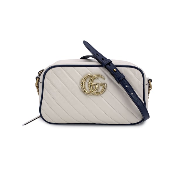 VINTAGE, RRP AS NEW
This beautiful Bag will come with a Certificate of ity provided by Entrupy. The certificate will be provided at no further cost.  Step into timeless elegance with this beautiful Gucci GG Marmont Small Zip Around Shoulder Bag, a true gem for lovers of vintage luxury. Crafted in soft white matelassé quilted leather, the bag is gracefully framed with navy blue leather trim-a nod to nautical chic that never goes out of style.  At the heart of its design, the iconic gold metal Torchon GG logo gleams proudly on the front, echoing Gucci's rich heritage. The bag zips open at the top to reveal a refined microfibre interior, complete with a convenient side pocket for your essentials.  The shoulder strap-an artful blend of adjustable navy leather and antique gold chain-lets you wear it crossbody or snug on the shoulder, adding versatility to its elegance. Inside, a discreet 'Gucci - Made in Italy' tag whispers top crftmanship, backed by a serial number hidden on its reverse.  A striking yet subtle piece, this GG Marmont model captures the spirit of classic Italian craftsmanship with a modern, collector-worthy twist.  Condition Rating: A - EXCELLENTCondition Details: Gently used. Minimal wear of use on leather trim. Minimal wear of use on the internal lining. Please check the photos carefully and ask if you need to know more details or if you have any doubts.Measurements (cm):Depth: 6.4Height: 12.7Length: 24.1Other Details: Dustbag? NoKeys? NoBox? No Measurments:  width: 64 mm length: 241 mm height: 127 mm strap length: 0 mm handle drop: 0 mm