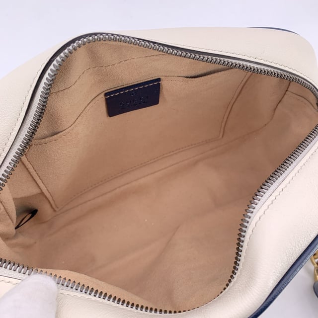 VINTAGE, RRP AS NEW
This beautiful Bag will come with a Certificate of ity provided by Entrupy. The certificate will be provided at no further cost.  Step into timeless elegance with this beautiful Gucci GG Marmont Small Zip Around Shoulder Bag, a true gem for lovers of vintage luxury. Crafted in soft white matelassé quilted leather, the bag is gracefully framed with navy blue leather trim-a nod to nautical chic that never goes out of style.  At the heart of its design, the iconic gold metal Torchon GG logo gleams proudly on the front, echoing Gucci's rich heritage. The bag zips open at the top to reveal a refined microfibre interior, complete with a convenient side pocket for your essentials.  The shoulder strap-an artful blend of adjustable navy leather and antique gold chain-lets you wear it crossbody or snug on the shoulder, adding versatility to its elegance. Inside, a discreet 'Gucci - Made in Italy' tag whispers top crftmanship, backed by a serial number hidden on its reverse.  A striking yet subtle piece, this GG Marmont model captures the spirit of classic Italian craftsmanship with a modern, collector-worthy twist.  Condition Rating: A - EXCELLENTCondition Details: Gently used. Minimal wear of use on leather trim. Minimal wear of use on the internal lining. Please check the photos carefully and ask if you need to know more details or if you have any doubts.Measurements (cm):Depth: 6.4Height: 12.7Length: 24.1Other Details: Dustbag? NoKeys? NoBox? No Measurments:  width: 64 mm length: 241 mm height: 127 mm strap length: 0 mm handle drop: 0 mm