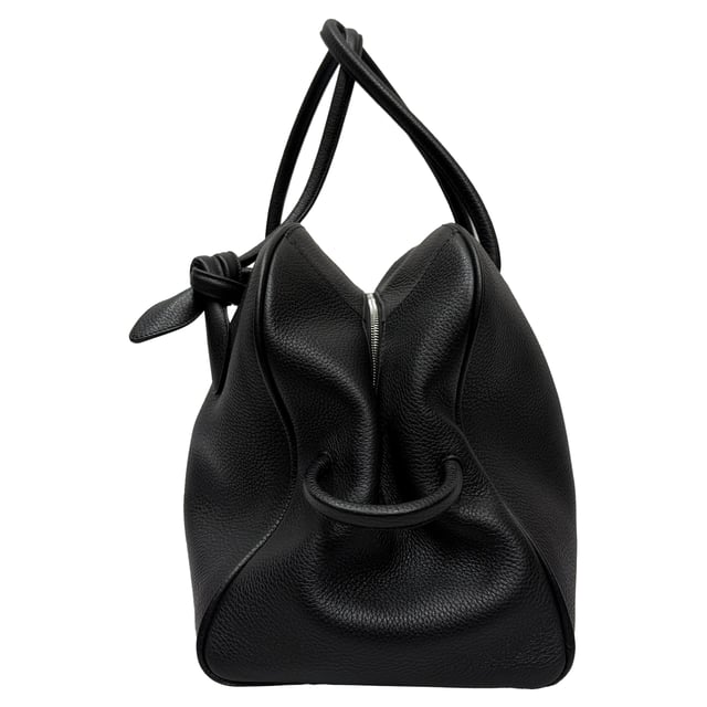 VINTAGE, RRP AS NEW
Travel in style with the Jacquemus Le Grand Turismo Holdall Weekend Bag, crafted in sleek black leather for a refined, minimalist aesthetic. Its structured silhouette, top handles, and subtle logo detailing make it both functional and fashion-forward. Pair it with a tailored coat, slim trousers, and leather sneakers for a polished weekend getaway look that speaks effortless sophistication.

 Jacquemus Le Grand Turismo Holdall Weekend Bag in Black Leather

Condition: Excellent
Signs of wear: No visible signs of wear
Packaging: None
Color: Black
Material: Leather | calfskin leather
Size: One Size | One Size
Measurements: Handle drop: 600 mm; Strap length: 00; Width 210 mm Height 290 mm Length 500 mm 
SKU: MRPPUGBBA531180M