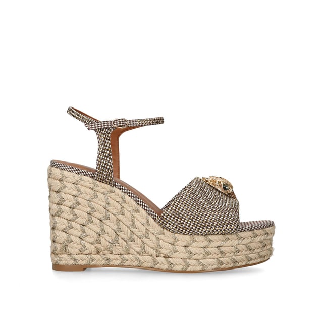 The Kensington Espadrille, an addition to the iconic Kensington collection, is crafted in a brown houndstooth embellished with gold crystals. The rope wedge heel features gold thread running through the heel. Heel height: 10.5cm.