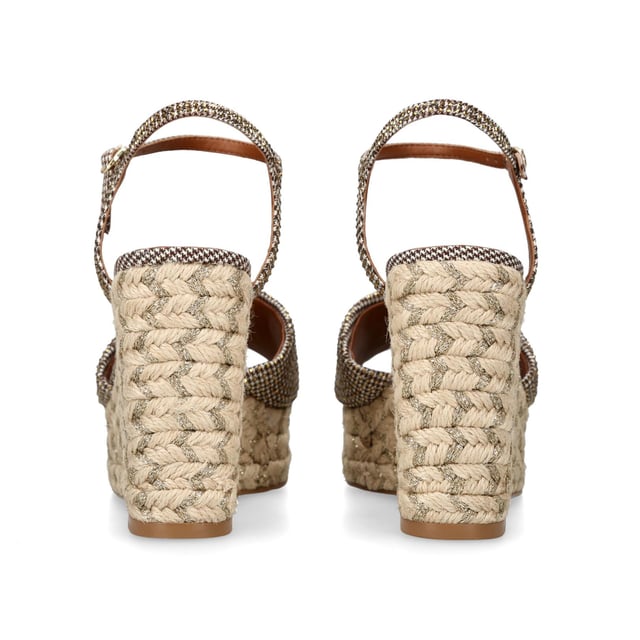 The Kensington Espadrille, an addition to the iconic Kensington collection, is crafted in a brown houndstooth embellished with gold crystals. The rope wedge heel features gold thread running through the heel. Heel height: 10.5cm.