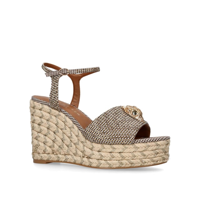 The Kensington Espadrille, an addition to the iconic Kensington collection, is crafted in a brown houndstooth embellished with gold crystals. The rope wedge heel features gold thread running through the heel. Heel height: 10.5cm.