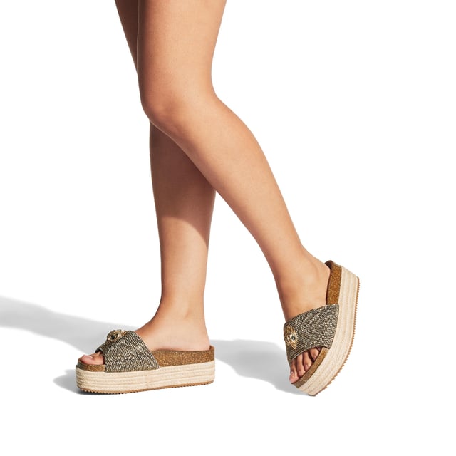 The Kensington Flatform, an addition to the Kensington Collection, features a houndstooth strap embellished with gold crystals. The gold Eagle head features crystals and black crystal eyes on the strap. Sole height: 4cm.