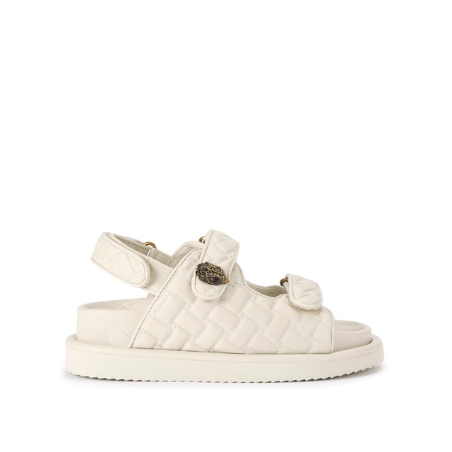 The Kurt Geiger Orson sandal features a bone soft upper with weave quilting pattern. The straps are velcro with an antiqued brass eagle head emblem sat on top. Over stitched quilted insole with padding, seen across the collections.