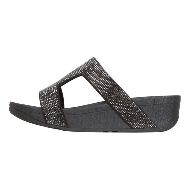 Marke: Fit Flop. Obermaterial: Microfaser. Futterstoff: Microfaser. Mittelsohle: Microwobbleboard. Laufsohle: Gummi, Rutschfest. Gewebetechnik: Weich. Absatz: Flacher Absatz. Design: Kristall, Verziert. Zum Anschlüpfen.