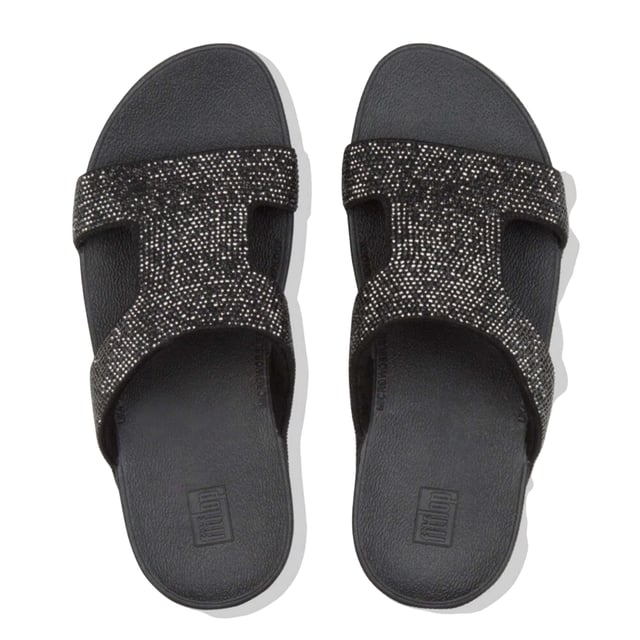 Marke: Fit Flop. Obermaterial: Microfaser. Futterstoff: Microfaser. Mittelsohle: Microwobbleboard. Laufsohle: Gummi, Rutschfest. Gewebetechnik: Weich. Absatz: Flacher Absatz. Design: Kristall, Verziert. Zum Anschlüpfen.