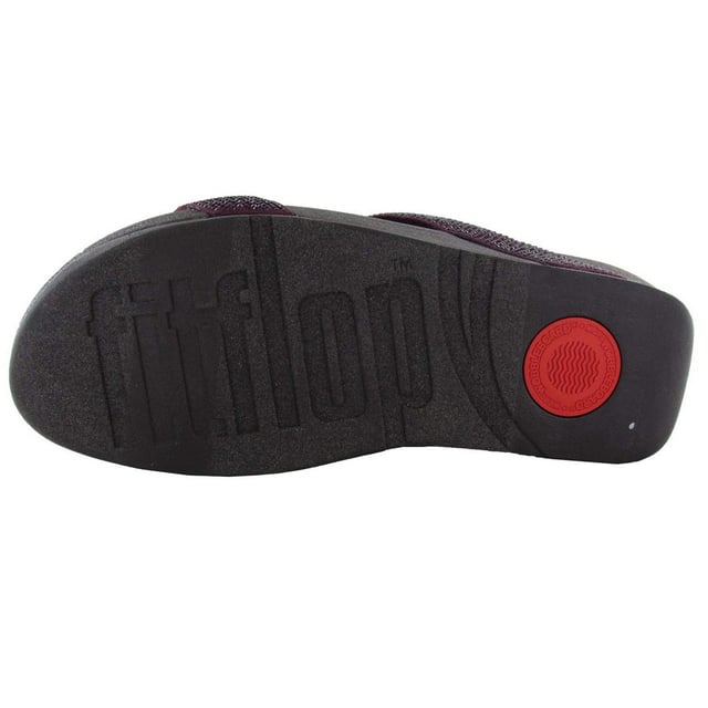Marke: Fit Flop. Obermaterial: Microfaser. Futterstoff: Microfaser. Mittelsohle: Microwobbleboard. Laufsohle: Gummi, Rutschfest. Gewebetechnik: Weich. Absatz: Flacher Absatz. Design: Kristall, Verziert. Zum Anschlüpfen.