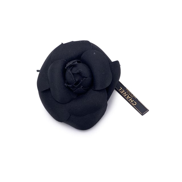 Chanel Vintage Cloth Brooch Camelia VINTAGE, RRP AS NEW
Chanel Vintage Camellia Flower Pin Brooch - Black Satin Timelessly feminine and unmistakably Chanel, this Vintage Camellia Flower Pin Brooch captures the Maison's enduring love for the iconic camellia bloom - a signature symbol of elegance and grace. Crafted from luxurious black satin, the layered petals create a soft yet sculptural silhouette that adds depth and dimension to any ensemble. Measuring approximately 4 inches (10.2 cm) in diameter, this striking brooch is designed to make a subtle yet refined statement. The piece secures with a classic safety pin closure, allowing it to be effortlessly styled on a lapel, hat, scarf, or handbag. On the reverse, the brooch is finished with the signature 'CHANEL - CC - Made in France' oval ity tab, affirming its heritage and craftsmanship. A true collector's piece, the Camellia Brooch brings vintage charm and Parisian sophistication to any look - elegant, understated, and eternally chic. Condition Rating: A - EXCELLENTCondition Details: Gently used. Chanel box included. Please check the photos carefully and ask if you need to know more details or if you have any doubts. Box?: ?: Yes Measurments: length: 102 mm strap length: 0 mm handle drop: 0 mm