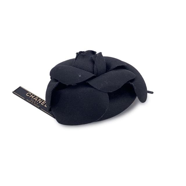 Chanel Vintage Cloth Brooch Camelia VINTAGE, RRP AS NEW
Chanel Vintage Camellia Flower Pin Brooch - Black Satin Timelessly feminine and unmistakably Chanel, this Vintage Camellia Flower Pin Brooch captures the Maison's enduring love for the iconic camellia bloom - a signature symbol of elegance and grace. Crafted from luxurious black satin, the layered petals create a soft yet sculptural silhouette that adds depth and dimension to any ensemble. Measuring approximately 4 inches (10.2 cm) in diameter, this striking brooch is designed to make a subtle yet refined statement. The piece secures with a classic safety pin closure, allowing it to be effortlessly styled on a lapel, hat, scarf, or handbag. On the reverse, the brooch is finished with the signature 'CHANEL - CC - Made in France' oval ity tab, affirming its heritage and craftsmanship. A true collector's piece, the Camellia Brooch brings vintage charm and Parisian sophistication to any look - elegant, understated, and eternally chic. Condition Rating: A - EXCELLENTCondition Details: Gently used. Chanel box included. Please check the photos carefully and ask if you need to know more details or if you have any doubts. Box?: ?: Yes Measurments: length: 102 mm strap length: 0 mm handle drop: 0 mm
