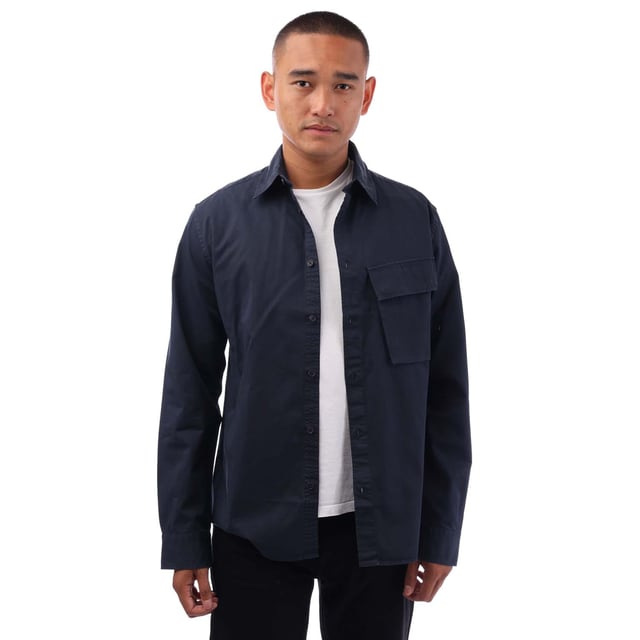 Point collar.Long sleeve.Centre front button fastening.Signature tilted flap pocket.Adjustable buttoned cuff.Belstaff Phoenix patch on sleeve.Garment-dyed cotton twill.