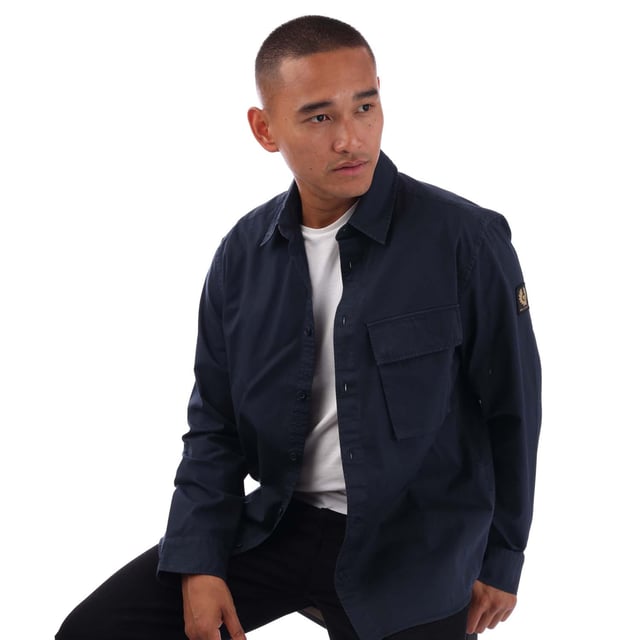 Point collar.Long sleeve.Centre front button fastening.Signature tilted flap pocket.Adjustable buttoned cuff.Belstaff Phoenix patch on sleeve.Garment-dyed cotton twill.
