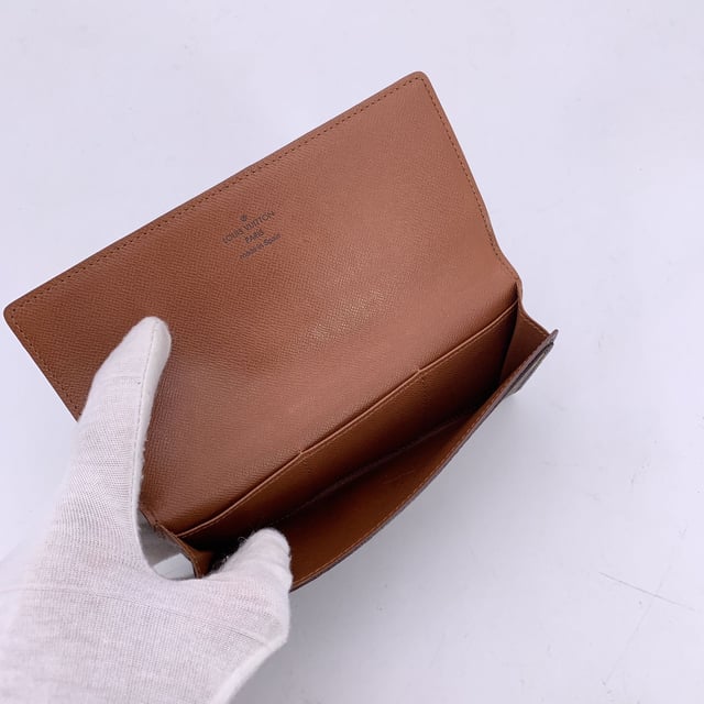 VINTAGE, RRP AS NEW
Step into timeless elegance with this vintage Louis Vuitton long bifold bill wallet, crafted from the Maison's signature brown monogram canvas. A classic piece that reflects the golden era of Louis Vuitton craftsmanship, this wallet exudes understated luxury with every detail.  Designed with a flap closure, the wallet opens to reveal a smooth leather lining, featuring one main compartment for bills, 3 smaller side open pockets and a convenient open pocket under the flap-perfect for receipts or essentials. Inside, you'll find the unmistakable 'LOUIS VUITTON Paris - Made in Spain' stamp, alongside the ity serial number (CA0938), confirming its heritage.  A refined yet practical piece, this vintage wallet carries not just currency, but the spirit of travel, history, and French savoir-faire. Ideal for collectors or lovers of classic luxury. Condition Rating: B - VERY GOOD CONDITIONCondition Details: Gently used. Some scratches on the internal lining. Please check the photos carefully and ask if you need to know more details or if you have any doubts.Measurements (cm): Height: 10.2Length: 17.8Box?: No Measurments:  length: 178 mm height: 102 mm strap length: 0 mm handle drop: 0 mm