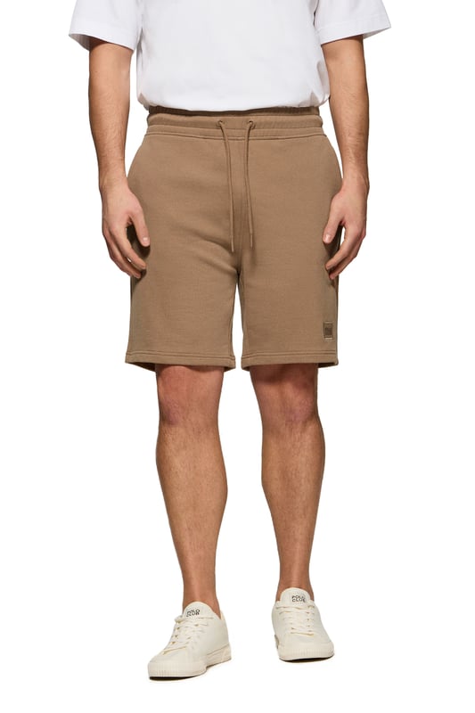 Polo Club bietet weiterhin Komfort und Stil mit der Bermuda Jonas. Der Stoff aus 100 % Baumwolle und die lockere Passform machen sie zu einem bequemen und modischen Kleidungsstück für sportliche Anlässe. Verstellbarer Kordelzug am Bund mit individueller Verzierung. Praktische Tasche auf der Hinterseite. Kleiner farblich abgestimter gummierter Twill-Aufnäher am vorderen Saum. 