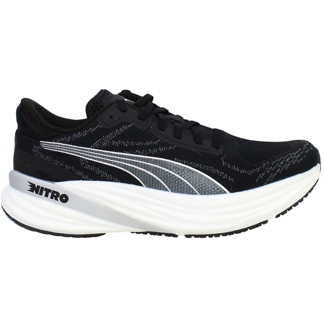 Puma Magnify Nitro 2 Womens Black Running Shoes The PUMA Magnify NITRO 2 Women’s Black is a high-stack, max‑cushioned trainer crafted for daily miles and long-distance comfort. Featuring full-length NITRO foam and a grippy outsole, these shoes deliver soft, responsive cushioning with standout traction and durability. With its sleek black colorway, engineered knit upper, and supportive feel, this edition offers both performance and everyday style.
Key Features
Full-Length NITROFOAM™ Midsole
Puma’s nitrogen-infused foam delivers plush yet responsive cushioning across the entire footbed—perfect for base miles and recovery runs.
Engineered Knit Upper with PWRTAPE Reinforcements
Premium knit fabric molds to the foot for comfort and breathability, while strategic overlay tape adds structural support and a secure fit.
PUMAGRIP Rubber Outsole with Targeted Coverage
Durable traction zones at key contact areas ensure reliable grip and stability on roads—even in damp conditions.
Generous Stack Height with Smooth Transition
Approximately 40 mm heel, 30 mm forefoot, and a 10 mm drop deliver an elevated, rocker-like gait without stiffness.
Moulded Heel Collar and Padded Tongue
Enhances rear-foot comfort and lockdown, reducing heel slippage and irritation on longer runs.