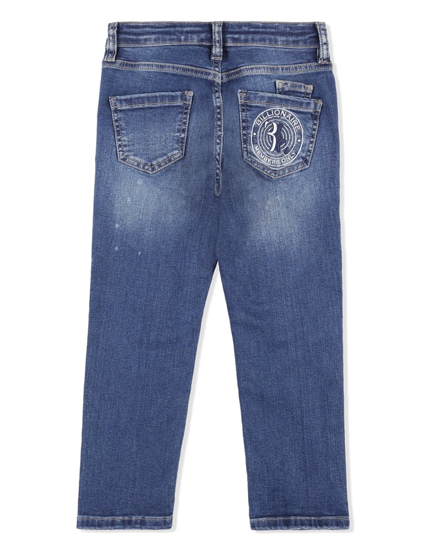 Los clásicos pantalones de denim desgastado de cinco bolsillos son indispensables, incluso en el armario de un niño. Este modelo incluye un botón de metal en la cintura. El bolsillo trasero derecho está adornado con el monograma de la firma bordado. Corte: Regular.