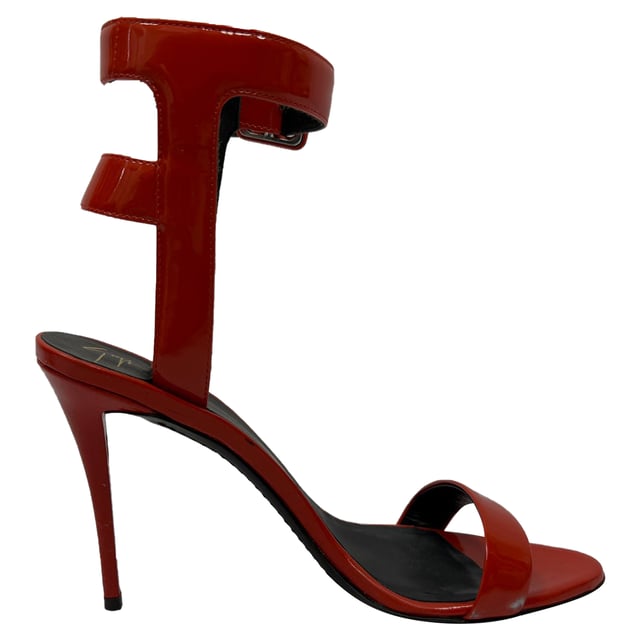 VINTAGE, RRP AS NEW
The Giuseppe Zanotti High Ankle Strap Sandal Heels in red patent leather are a show-stopping fusion of bold color and architectural elegance. With a sculptural stiletto heel, glossy finish, and high ankle strap, they command attention and elevate any ensemble. **Style Tip:** Keep the rest of your look sleek and simple—think a little black dress or fitted monochrome jumpsuit—to let these fiery heels take center stage.

 Giuseppe Zanotti High Ankle Strap Sandal Heels in Red Patent Leather

Condition: Excellent
Signs of wear: No visible signs of wear
Packaging: Box, Dust bag
Color: Red 
Material: Leather | patent leather
Size: IT | 37.5
Measurements: Heel height: 100 mm; Insole length: 270 mm
SKU: TONPUGBSH509156W
