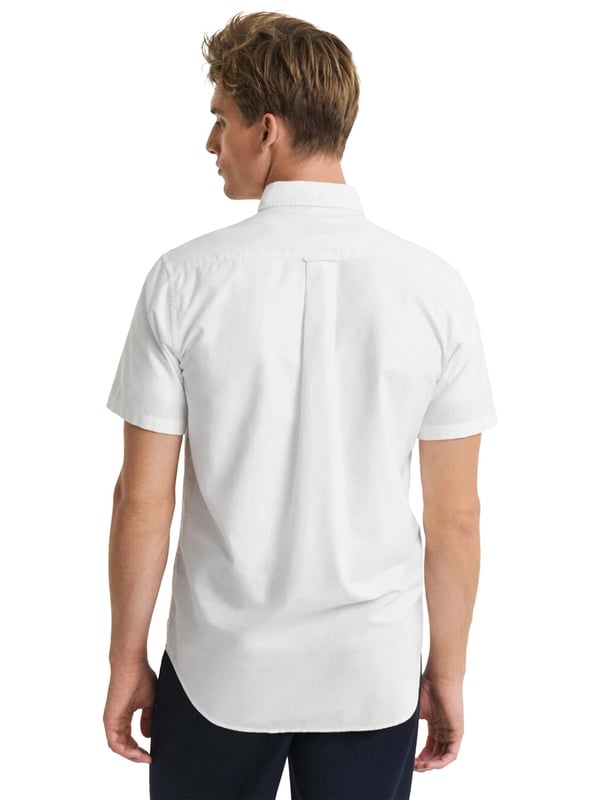 Timeless and versatile, the Classic Oxford Shirt is a smart-casual essential crafted from durable cotton. Designed in a regular fit with short sleeves, it’s perfect for the warmer months. Details include a button-down collar, curved hem, chest pocket with shield embroidery, and a box pleat with locker loop at the back for added comfort and style.