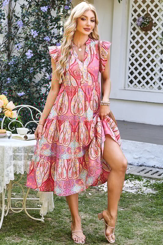 Elegante vestido midi con vibrante estampado tribal de paisley floral  
Mangas con volantes para un toque juguetón y femenino  
Escote en forma de pico para un detalle moderno y sofisticado  
Tejido suave y fluido para comodidad y libertad de movimiento  
Material: 84% Viscosa 16% Poliamida