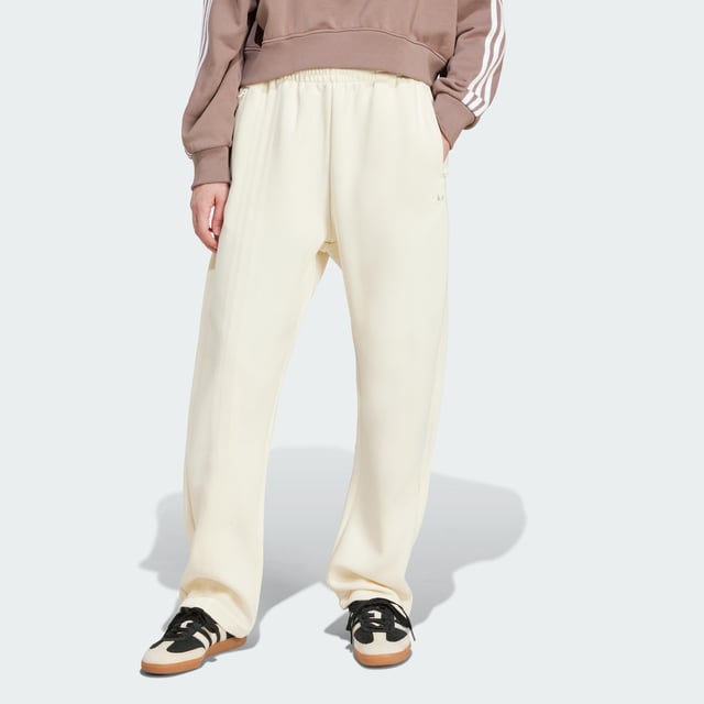 Remix your off-duty look with these adidas sweat pants. Inspired by martial arts and studio sports, they have a relaxed shape and a soft cotton-blend build that gives them an effortless vibe. Classic 3-Stripes on one leg add a signature finish to the casual design.By choosing recycled, adidas are able to reuse materials that have already been created, which helps to reduce waste. Renewable materials choices will help us to remove our reliance on finite resources. Our products made with a blend of recycled and renewable materials feature at least 70% total of these materials.  - Loose fit - Drawcord on elastic waist - 53% cotton, 47% polyester (recycled) - Side pockets - Contains a minimum of 70% recycled and renewable content  Shipped by adidas