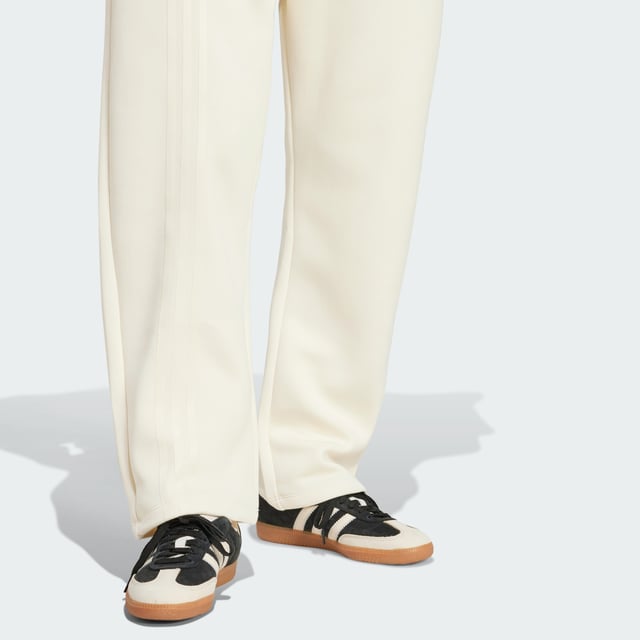 Remix your off-duty look with these adidas sweat pants. Inspired by martial arts and studio sports, they have a relaxed shape and a soft cotton-blend build that gives them an effortless vibe. Classic 3-Stripes on one leg add a signature finish to the casual design.By choosing recycled, adidas are able to reuse materials that have already been created, which helps to reduce waste. Renewable materials choices will help us to remove our reliance on finite resources. Our products made with a blend of recycled and renewable materials feature at least 70% total of these materials.  - Loose fit - Drawcord on elastic waist - 53% cotton, 47% polyester (recycled) - Side pockets - Contains a minimum of 70% recycled and renewable content  Shipped by adidas