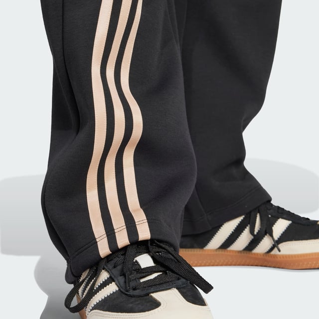 Remix your off-duty look with these adidas sweat pants. Inspired by martial arts and studio sports, they have a relaxed shape and a soft cotton-blend build that gives them an effortless vibe. Classic 3-Stripes on one leg add a signature finish to the casual design.By choosing recycled, adidas are able to reuse materials that have already been created, which helps to reduce waste. Renewable materials choices will help us to remove our reliance on finite resources. Our products made with a blend of recycled and renewable materials feature at least 70% total of these materials.  - Loose fit - Drawcord on elastic waist - 53% cotton, 47% polyester (recycled) - Side pockets - Contains a minimum of 70% recycled and renewable content  Shipped by adidas