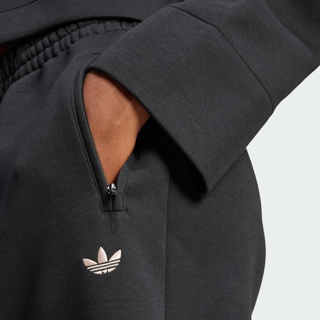 Remix your off-duty look with these adidas sweat pants. Inspired by martial arts and studio sports, they have a relaxed shape and a soft cotton-blend build that gives them an effortless vibe. Classic 3-Stripes on one leg add a signature finish to the casual design.By choosing recycled, adidas are able to reuse materials that have already been created, which helps to reduce waste. Renewable materials choices will help us to remove our reliance on finite resources. Our products made with a blend of recycled and renewable materials feature at least 70% total of these materials.  - Loose fit - Drawcord on elastic waist - 53% cotton, 47% polyester (recycled) - Side pockets - Contains a minimum of 70% recycled and renewable content  Shipped by adidas