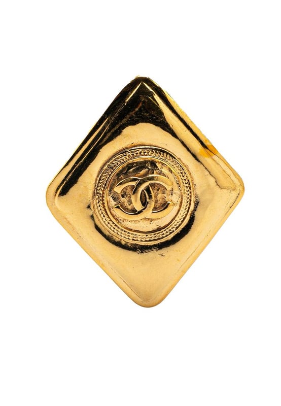 This brooch features a gold-tone metal body and a back pin closure.Brand: Chanel VintageCondition: PrelovedType: Costume BroochRating: B+Main Material: MetalDimensions (LxWxD): 5x4.2x0Comments: Exterior Back Scratched. Lock Scratched. Exterior Front Scratched.