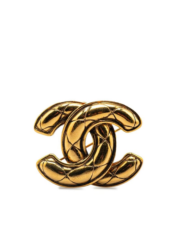 This brooch features a quilted gold-plated body and a back pin closure.Brand: Chanel VintageCondition: PrelovedType: Costume BroochRating: B+Main Material: MetalDimensions (LxWxD): 3.6x5x0Comments: Exterior Back Scratched. Exterior Back stained with Other. Lock Scratched. Exterior Front Scratched.