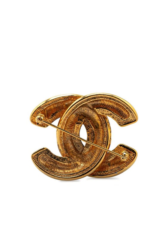 This brooch features a quilted gold-plated body and a back pin closure.Brand: Chanel VintageCondition: PrelovedType: Costume BroochRating: B+Main Material: MetalDimensions (LxWxD): 3.6x5x0Comments: Exterior Back Scratched. Exterior Back stained with Other. Lock Scratched. Exterior Front Scratched.