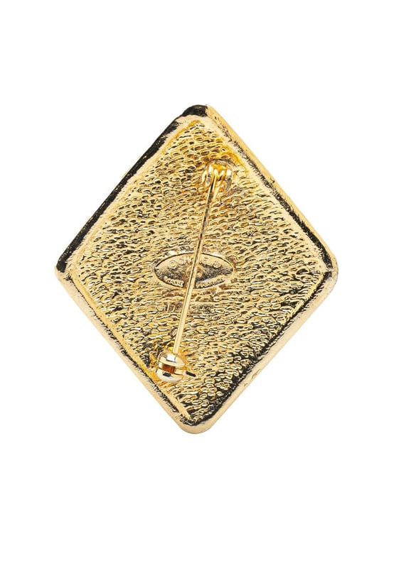 This brooch features a gold-tone metal body and a back pin closure.Brand: Chanel VintageCondition: PrelovedType: Costume BroochRating: B+Main Material: MetalDimensions (LxWxD): 4.7x4x0Comments: Lock Scratched. Exterior Front Scratched.