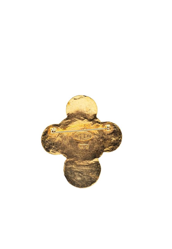 This brooch features a gold-tone metal body and a back pin closure.Brand: Chanel VintageCondition: PrelovedType: Costume BroochRating: B+Main Material: MetalDimensions (LxWxD): 6x5.2x0Comments: Exterior Back Discolored Scratched. Lock Scratched. Exterior Front Scratched.