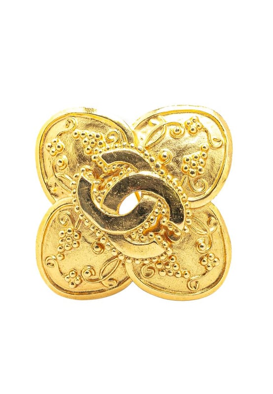 This brooch features a gold-tone metal body and a back pin closure.Brand: Chanel VintageCondition: PrelovedType: Costume BroochRating: B+Main Material: MetalDimensions (LxWxD): 4x4x0Comments: Exterior Back Scratched. Lock Scratched. Exterior Front Scratched.